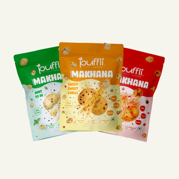 Three packages of puffli Makhana snacks in green, yellow, and red on a white background